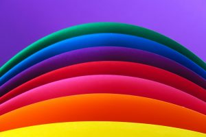 A rainbow on a purple background.