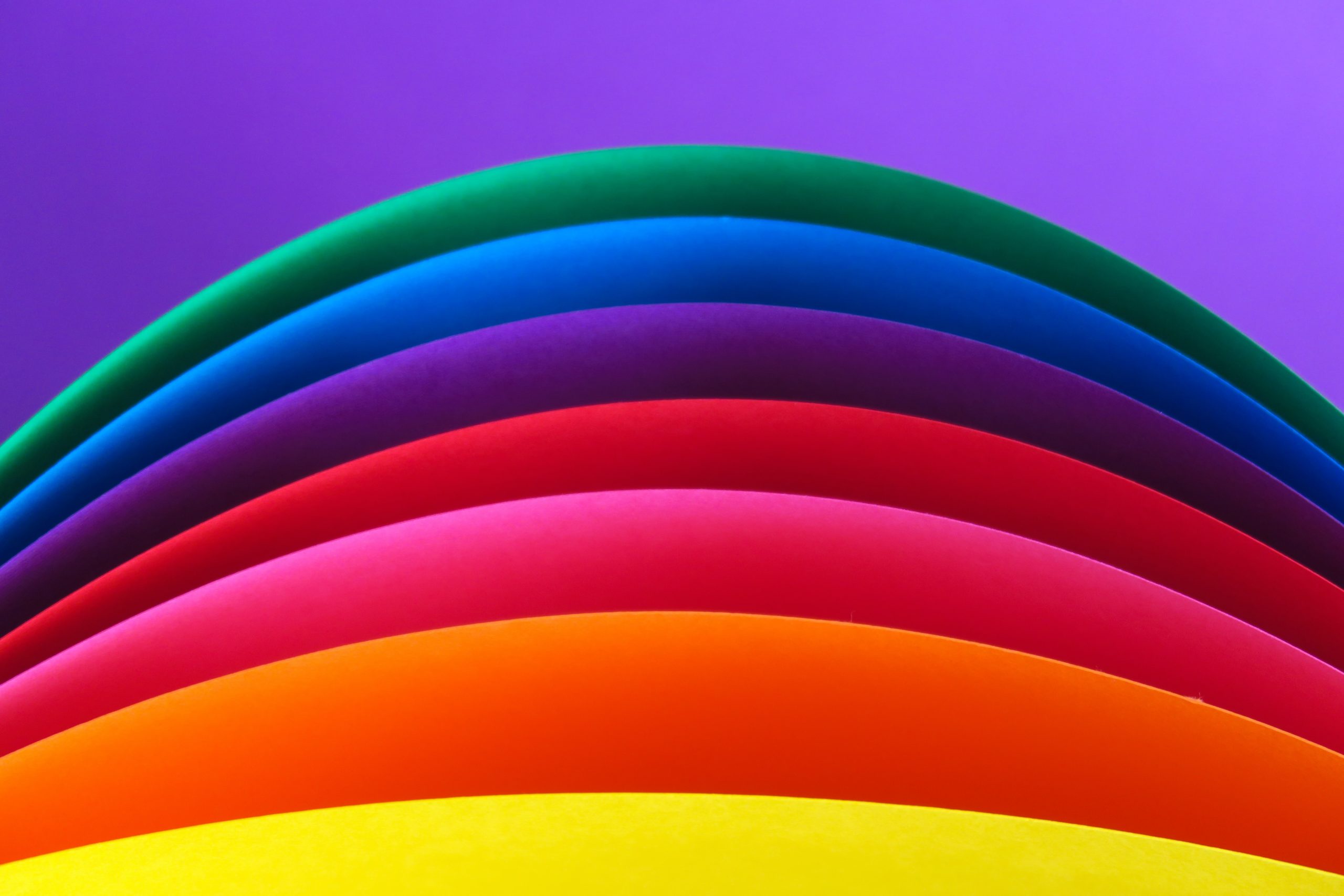 A rainbow on a purple background.