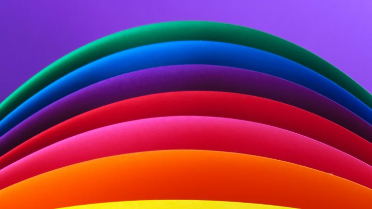 A rainbow on a purple background.